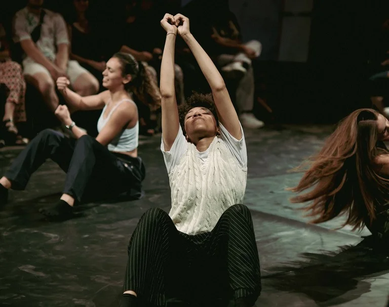 Several young people dance with great expression on a stage