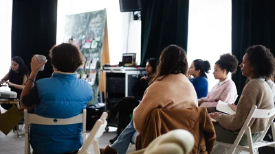 Workshop attendees are listening to a presentation.