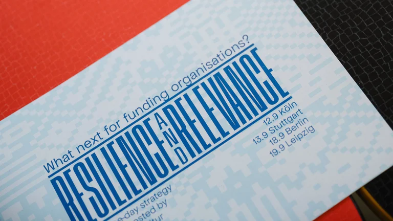 The programme booklet lies on a table