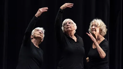 Three elderly women dancing