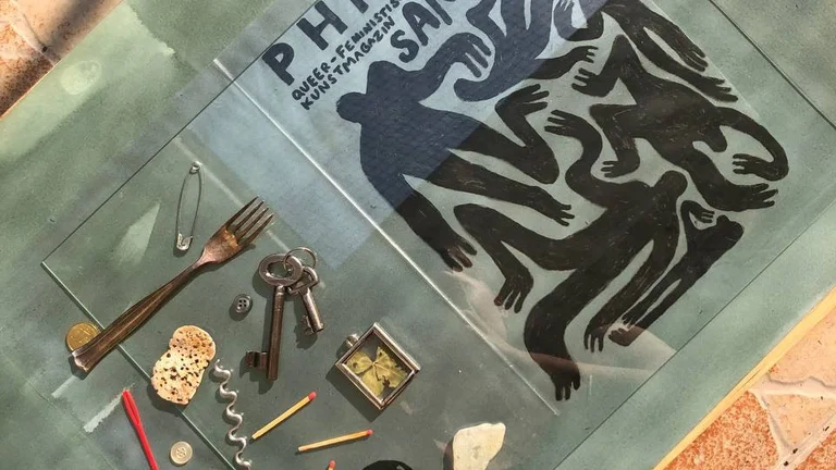 Top view of a magazine cover page that reads ‘Collecting’. Next to it are various objects such as keys, a fork, button or matches.
